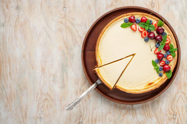 istock Cheesecake New York with berries on a plate on a bright background. Top view 1322607909