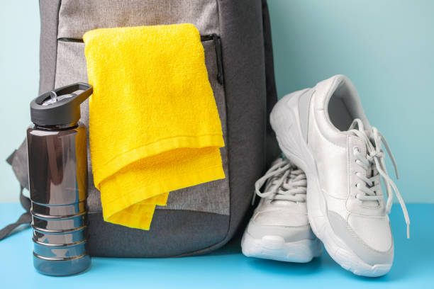 istock Sports bag, towel, bottle and sneackers on a colored background 1322607946