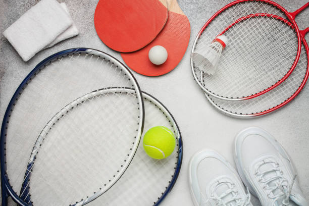 istock Tennis paddle rackets with ball on grey background. Summer sport activity concept. Top view 1322607967