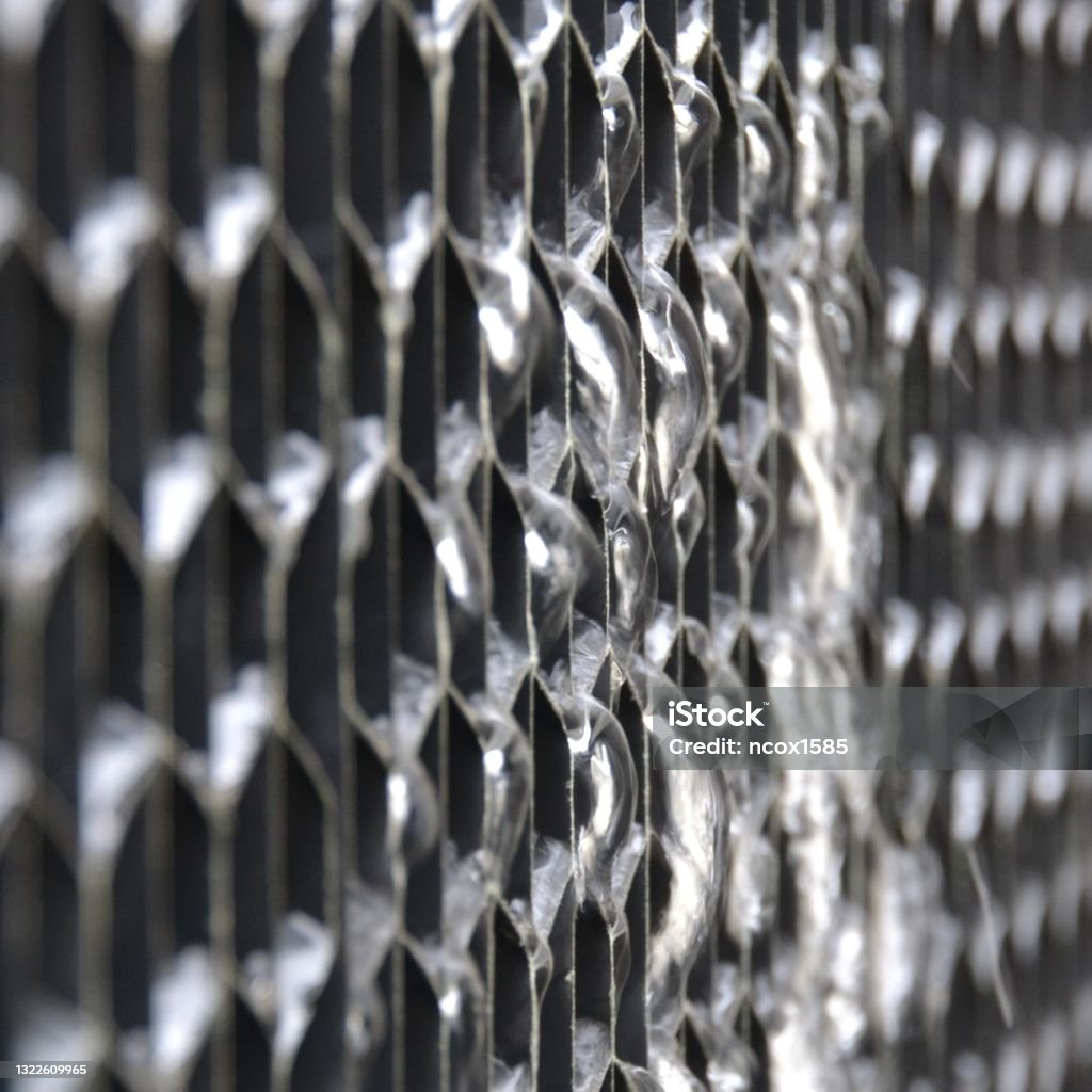 Closeup view of water leak or losses flowing from the plastic air intake louvre on a cooling tower system Water loss in industrial setting Air Conditioner Stock Photo