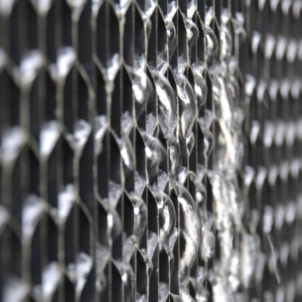 Closeup view of water leak or losses flowing from the plastic air intake louvre on a cooling tower system stock photo