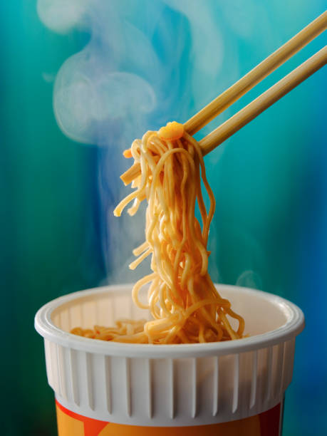 istock Hot, ready to eat, Asian instant cup noodles on chopsticks. 1322610622