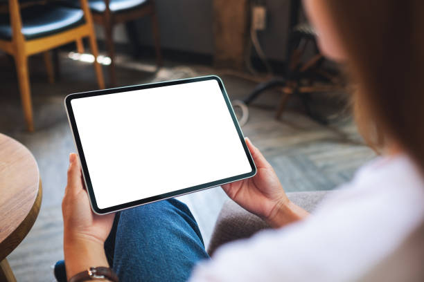istock a woman holding digital tablet with blank white desktop screen 1322614236