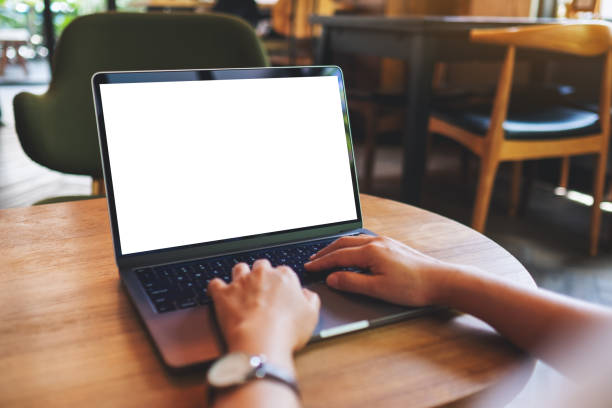 istock a woman using and typing on laptop computer with blank white desktop screen in cafe 1322614244
