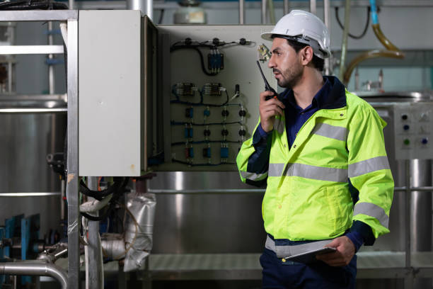 istock engineer or factory worker using tablet computer and walkie talkie for finding how to use machine control panel in factory 1322621354