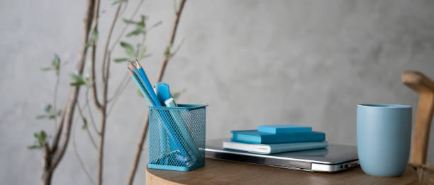istock Pencil holder, notebook, coffee cup and laptop on wooden table. 1322621531