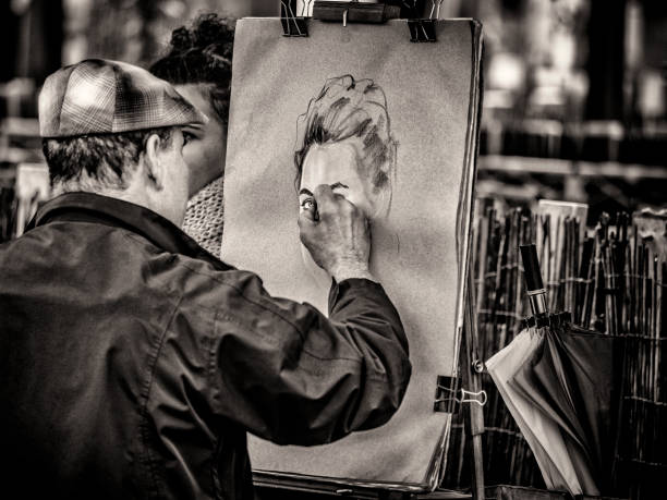 The City of Paris France on May 19, 2016:  Street artists painting portraits in the Montmartre area of Paris France