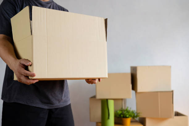 istock House moving concept. Man holding cardboard box, closeup. 1322627345