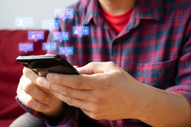 istock man hand using smartphone with colorful application icons around 1322627348