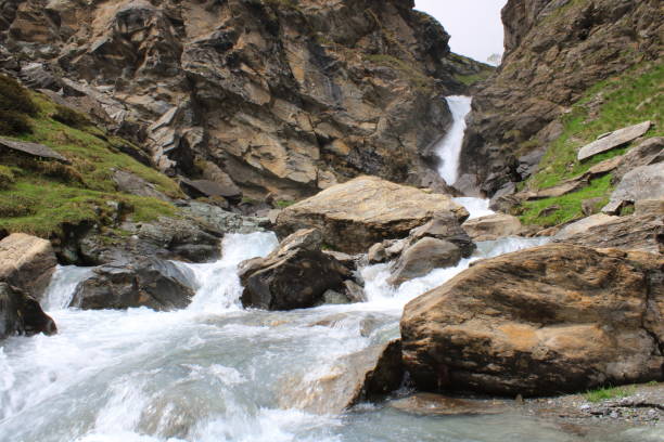 istock waterfall and stream high in the mountains 1322628532