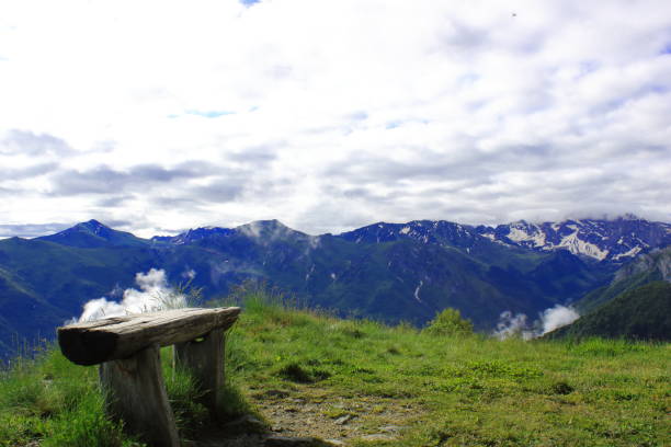 istock bench overlooking the snowy alpine chain 1322628641
