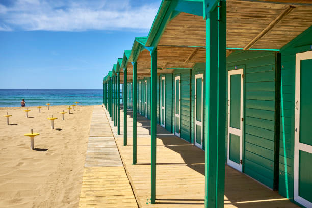 colored wooden cabins of a bathhouse on the Italian coast