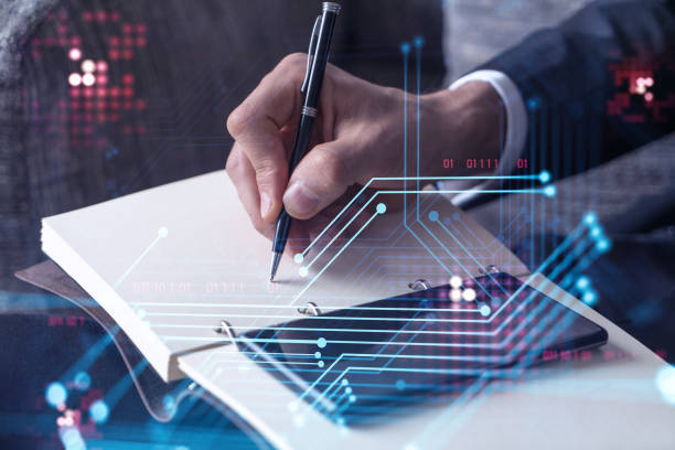 istock Arm in formal wear writing down some ideas using phone to create innovative software to provide a completely new high-tech service. Close up shot. Hologram tech graphs. Concept of Dev team 1322630076