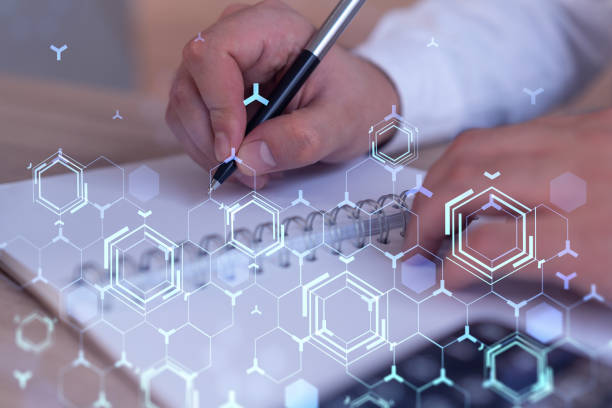 istock Hands writing down some ideas to create innovative software to change the world and provide a completely new service. Close up shot. Hologram tech graphs. Concept of Dev team. Formal wear. 1322630080