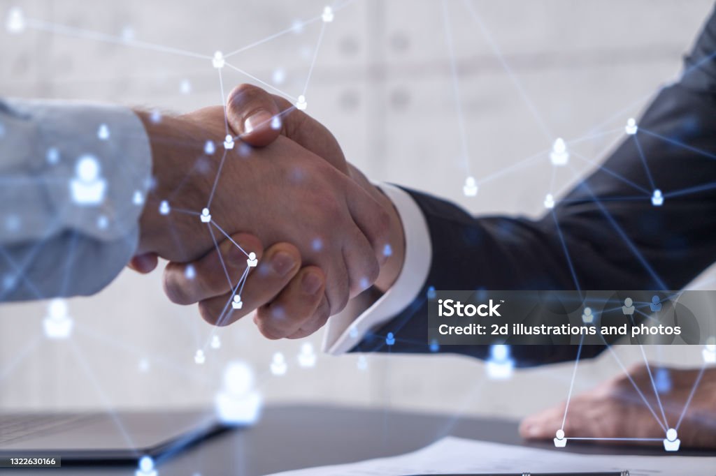 Recruitment concept to hiring of a new talented specialists for international company. Handshake to sign in of employment agreement. Social media hologram icons over the table with documents. Handshake Stock Photo