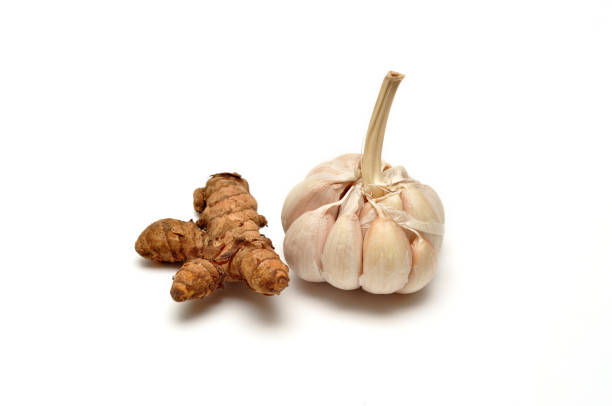 istock Close up fresh garlic and turmeric on white background 1322632323
