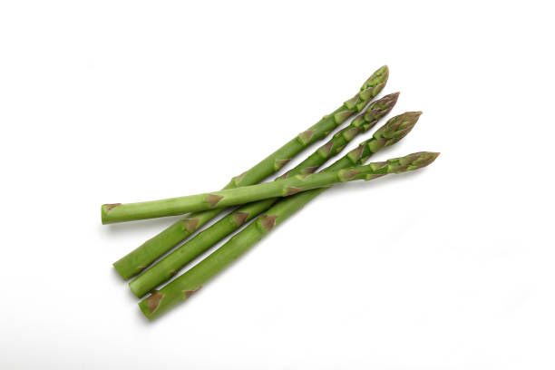 istock Fresh green asparagus on white background 1322632515