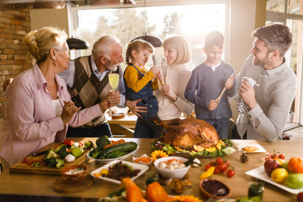 istock Happy extended family talking on Thanksgiving day. 1322632597