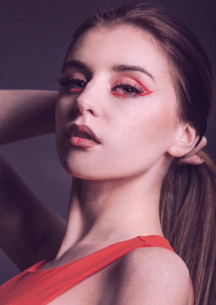 istock beautiful woman with creative make up in red 1322633359