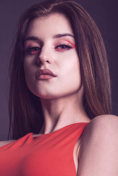 istock beautiful woman with creative make up in red 1322633368