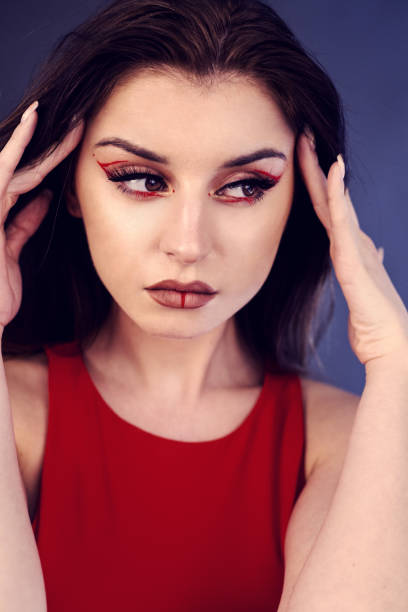 istock beautiful woman with creative make up in red 1322633373