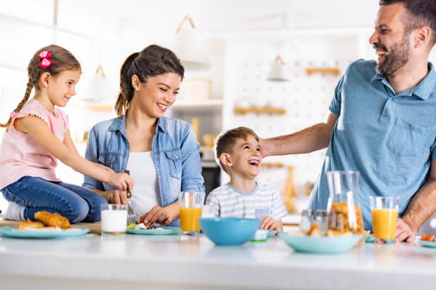 istock Happy family talking during breakfast in dining room. 1322633788