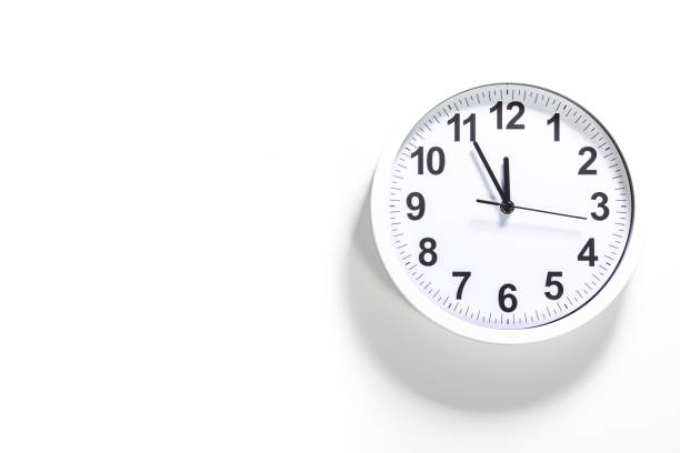 istock Close up to a wall clock, with five minutes to twelve o'clock 1322634013