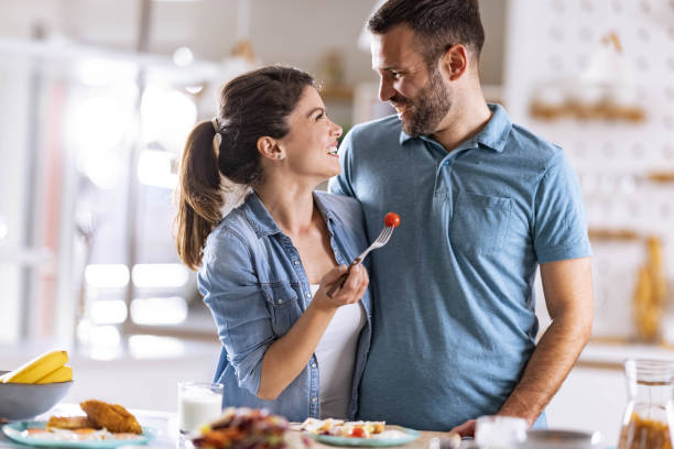 istock Happy couple talking while having a meal in the kitchen. 1322634096