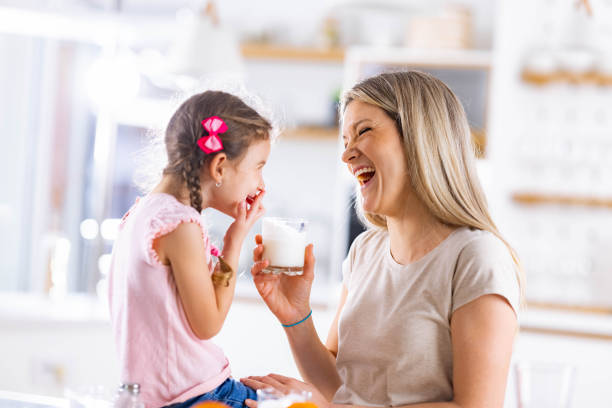 istock Cheerful single mother and daughter talking at home. 1322634207