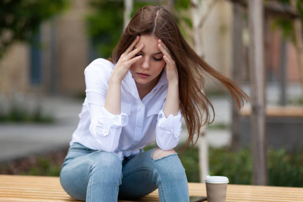 istock Women's problems. Upset girl sits outdoors. Burnout, mental trauma 1322636764