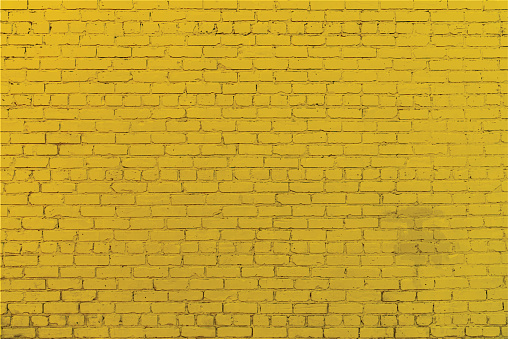 Yellow brick wall grunge vector background with copy space.