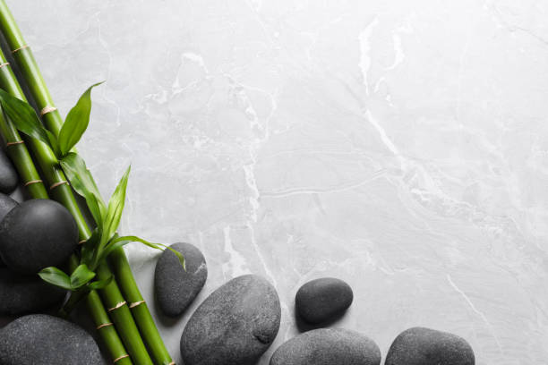 istock Spa stones and bamboo stems on light grey table, flat lay. Space for text 1322639305