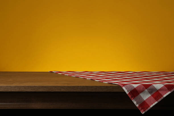 istock Red checkered textile napkin on wooden table. Space for text 1322639533