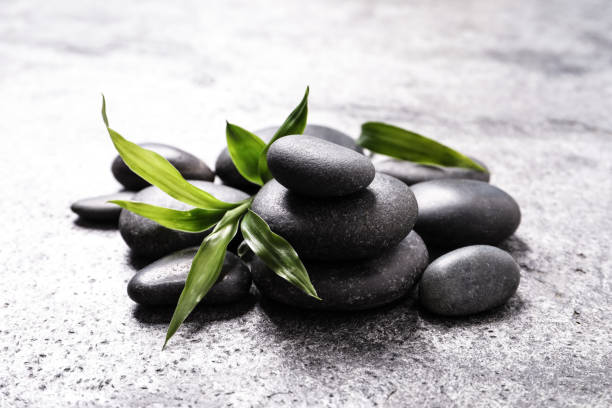 istock Spa stones and bamboo sprout on grey table 1322639555
