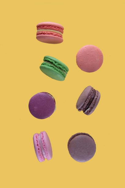 istock macaroons of different colours levitating on yellow background 1322639739