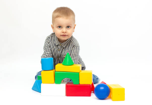 istock toddler child boy playing toy blocks isolated on white 1322641147