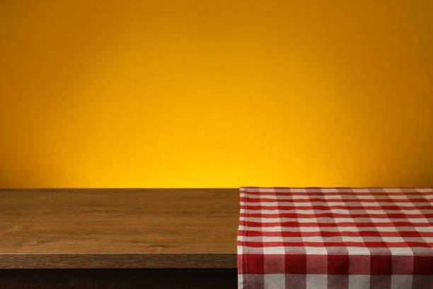 istock Red checkered textile napkin on wooden table. Space for text 1322641248