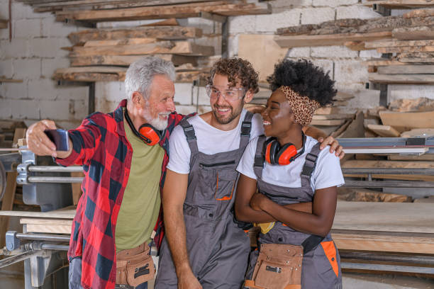 istock A Group of Carpenters is Enjoying in Taking Selfies in Large Workshop. 1322642063