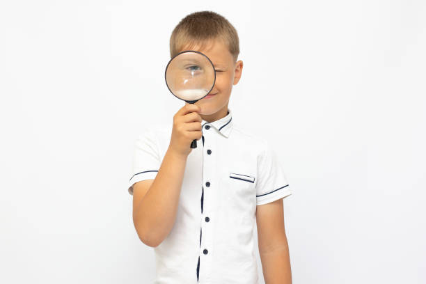 istock Children development, education concept. Child looking through a magnifying glass loop, closeup 1322642090