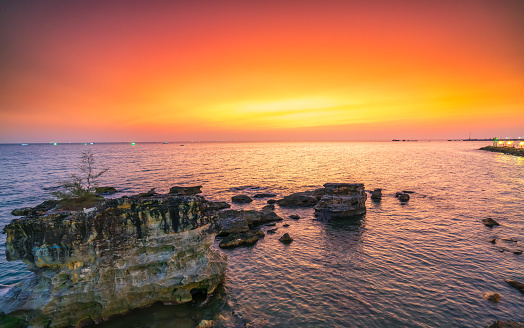 Sunset on the bay colorful sky, below is a large rock formation towards the horizon abstract create stunning scenery to admire nature