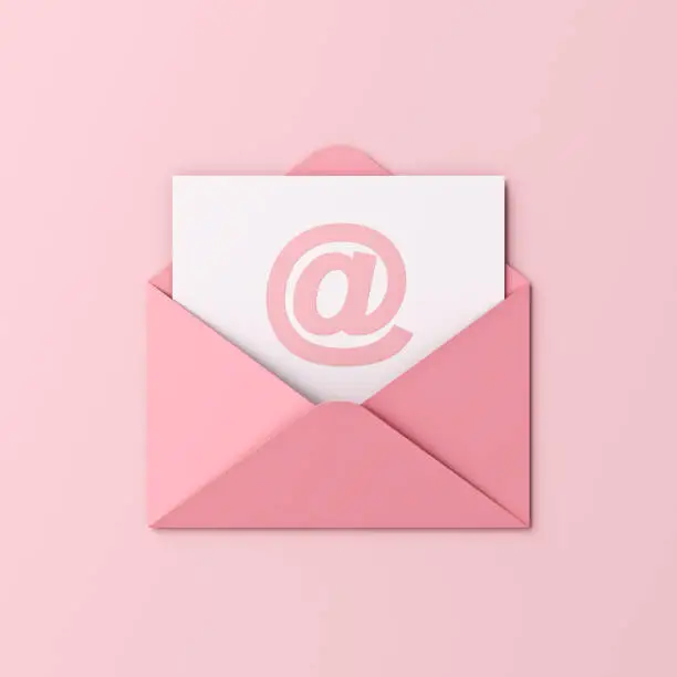 Photo of Sweet pink pastel color email or e-mail at sign in envelope isolated on light pink background with shadow minimal conceptual