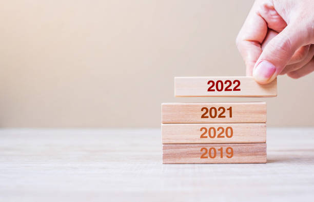 istock Businessman hand pulling 2022 wooden building blocks on table background. Business planning, Risk Management, Resolution, strategy, solution, goal, New Year New You and happy holiday concepts 1322650038