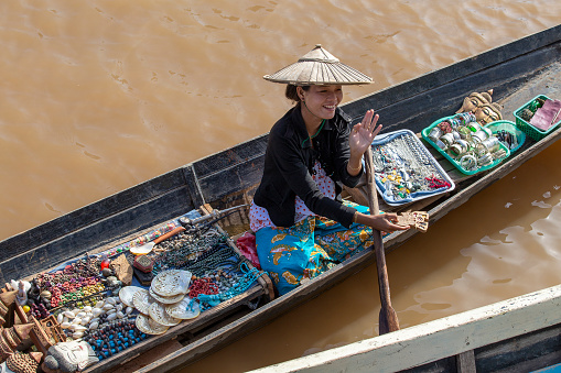 Inle lake, Myanmar, Burma - jan 14, 2016 : Unidentified Burmese woman on small long wooden boat selling souvenirs, trinkets and bijouterie at the floating market on Inle Lake, Myanmar
