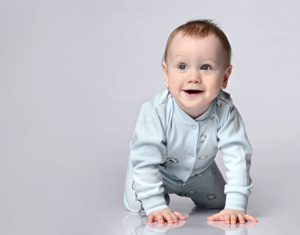 istock side view of pretty crawling baby 1322652164