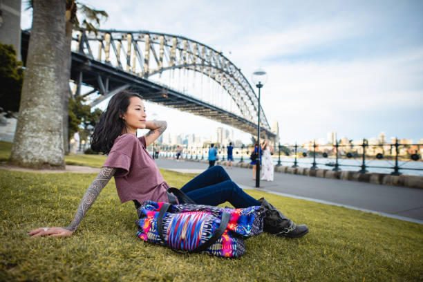 istock Asian woman relaxing and using smart phone in Sydney 1322655940