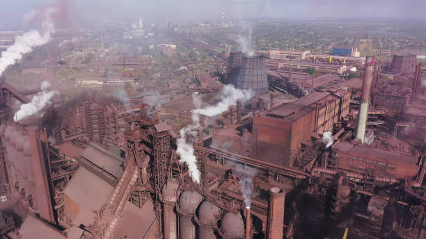 Smoke and grime from a steel mill. Aerial view. Smoke and grime from a steel mill. Aerial view. Environmental pollution chimney photos stock pictures, royalty-free photos & images