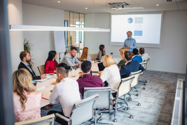 istock Mature Businessman Making Presentation to Colleagues 1322656509