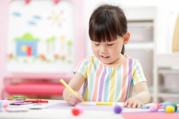 istock Cute Girl Drawing At Home 1322657139