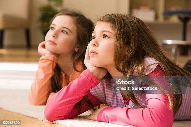 Foto de Duas Irmãs Deitado No Chão Olhando Para Cima e mais fotos de stock de 8-9 Anos - 8-9 Anos, Arte, Cultura e Espetáculo, Assistindo