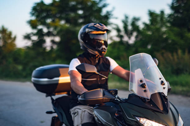 istock Man rides motorcycle on the road 1322659566